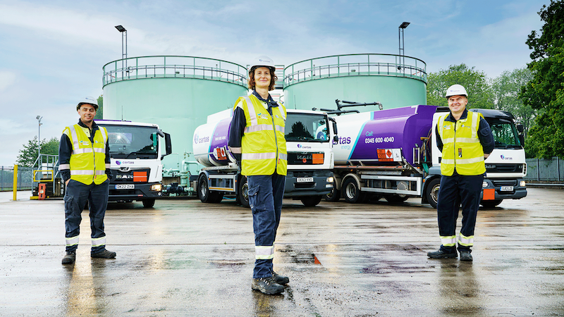 Certas Energy employee representatives stood in front of branded oil trucks.