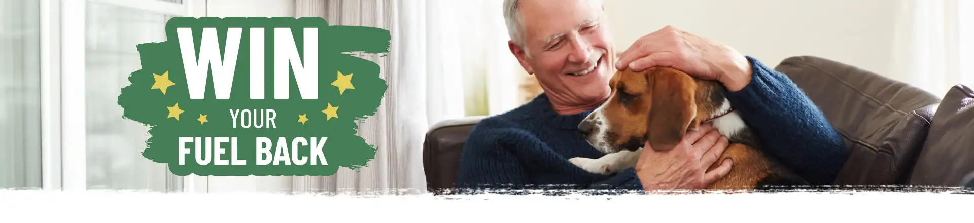Man sat on sofa smiling at dog with a Win Your Fuel Back logo overlay.