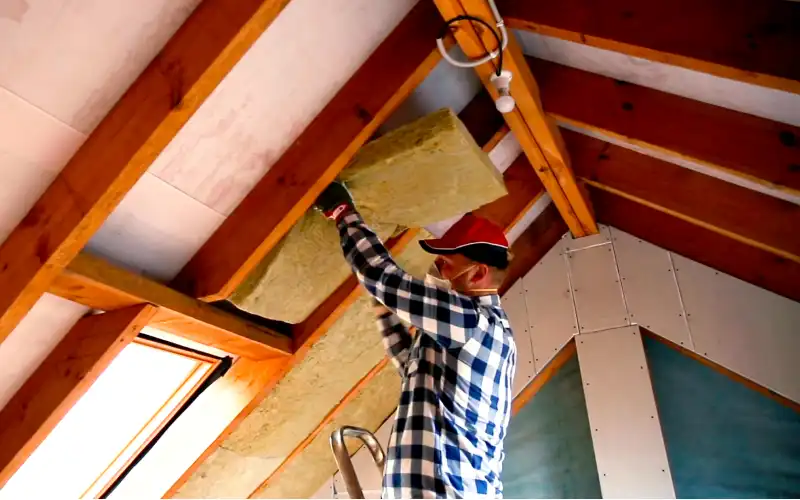 Man installing roof insulation.