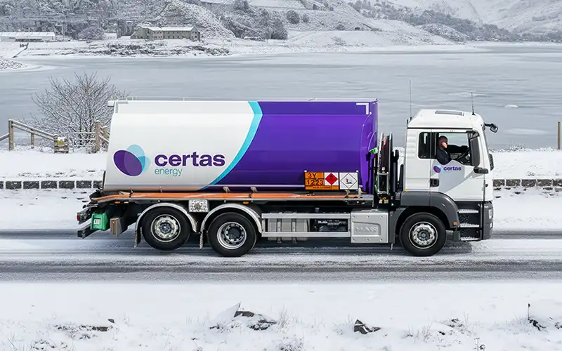 Certas Energy oil tanker driving through snow.