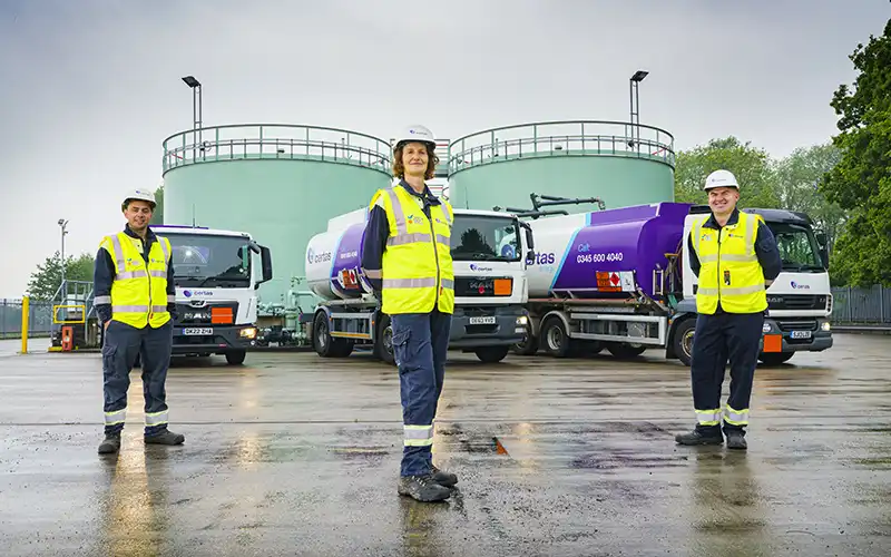 3 members of Certas Energy staff stood on forecourt.